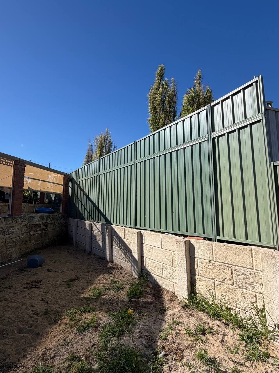 Retaining wall with Colorbond fence on top