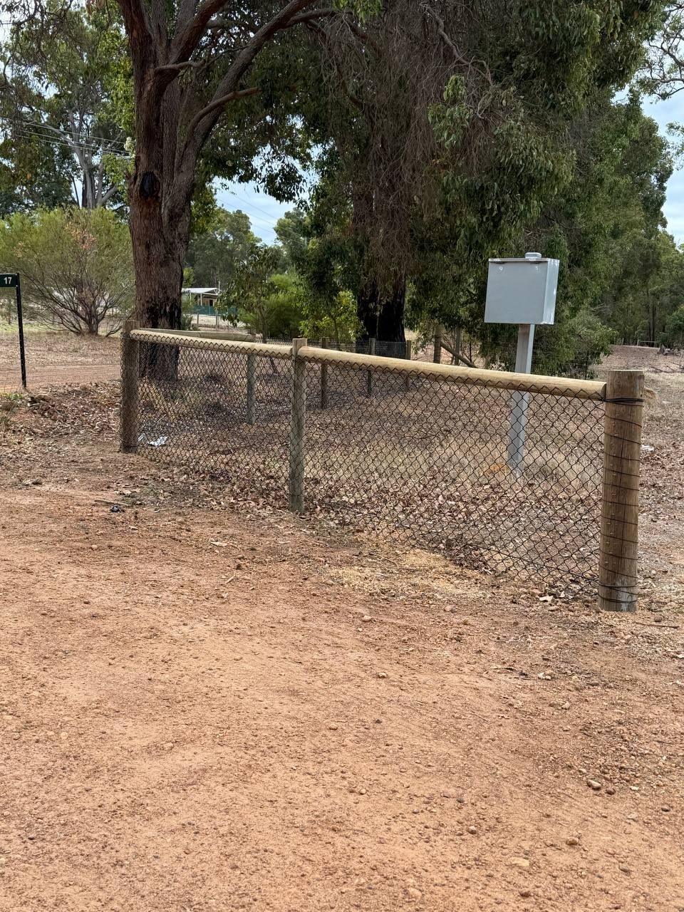 Chain-mesh stock fence with timber top rail