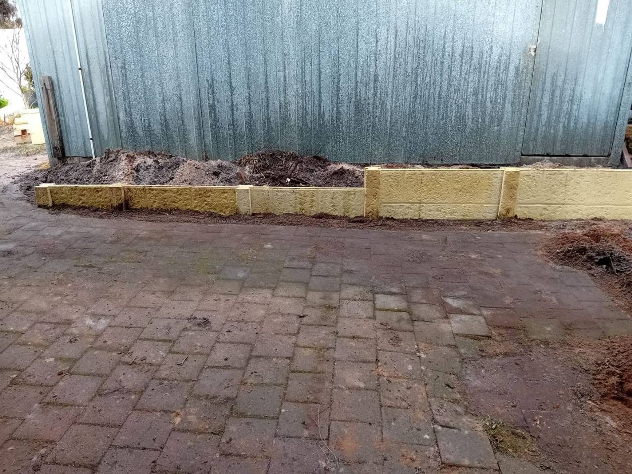 Work in progress: retaining wall along the shed